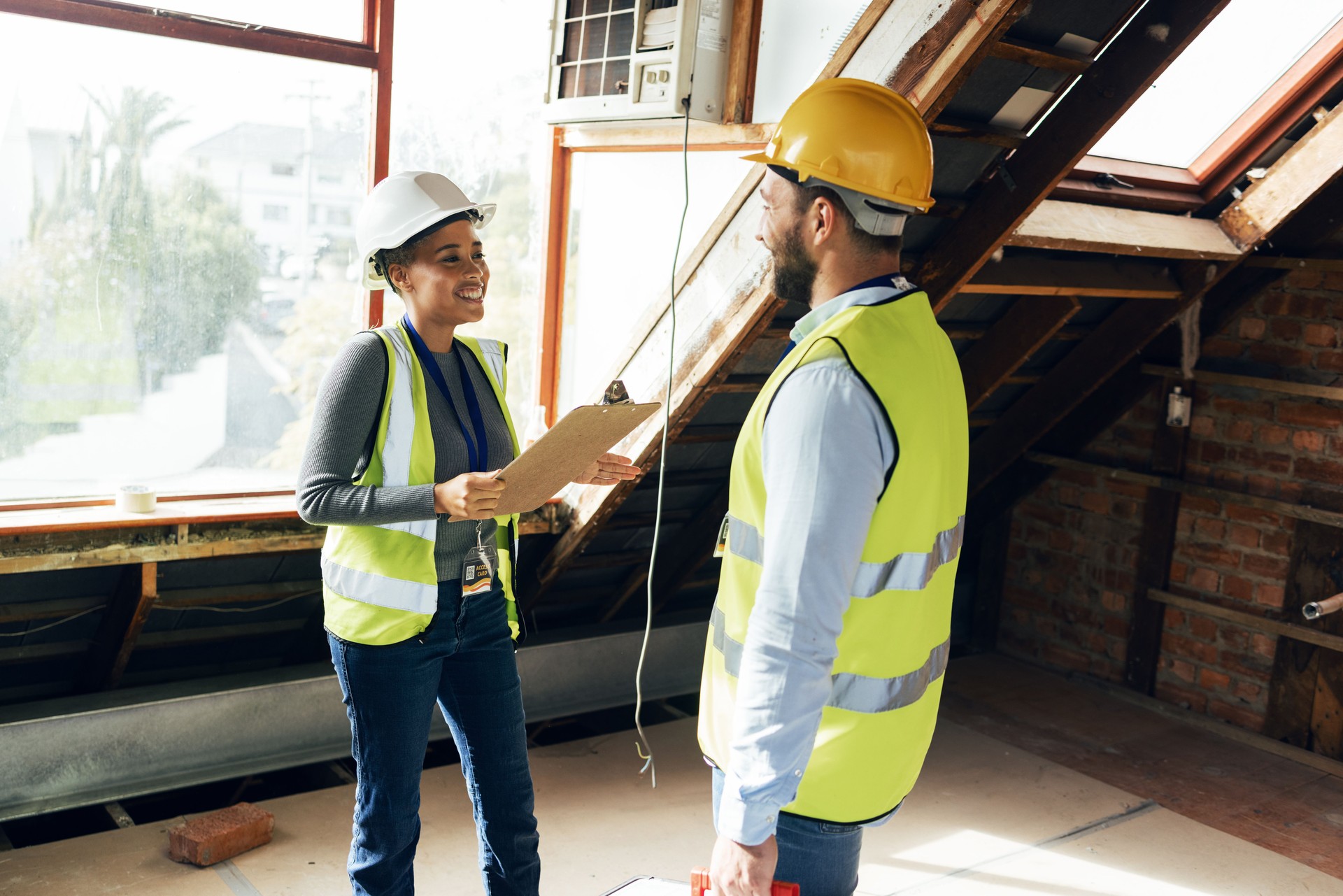 Engineering team, talking and planning together for a building construction or renovation project with teamwork, collaboration and communication. Man and woman engineer or technician talk development